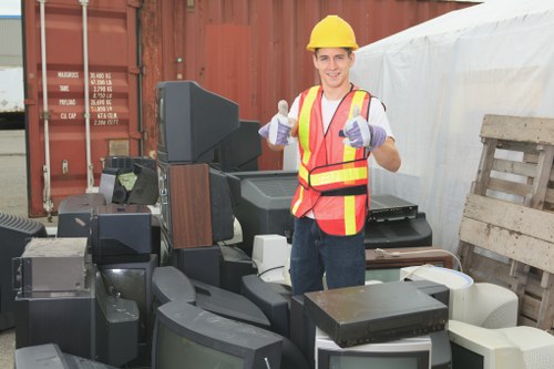 People transporting old furniture for disposal in Raynes Park.