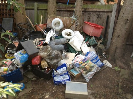 Workers managing builders waste clearance on a construction site